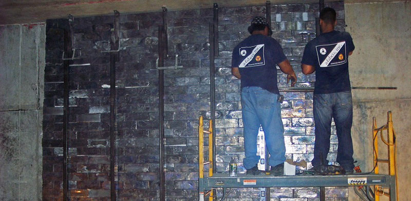 Interlocking lead bricks stacked in a vault wall