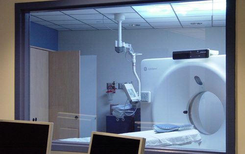 CT scanner seen through a lead glass control window